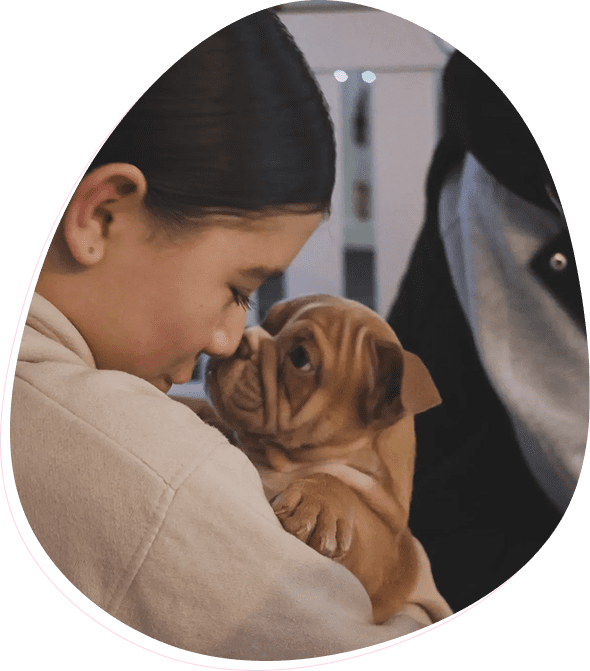 Girl cuddling a cute puppy