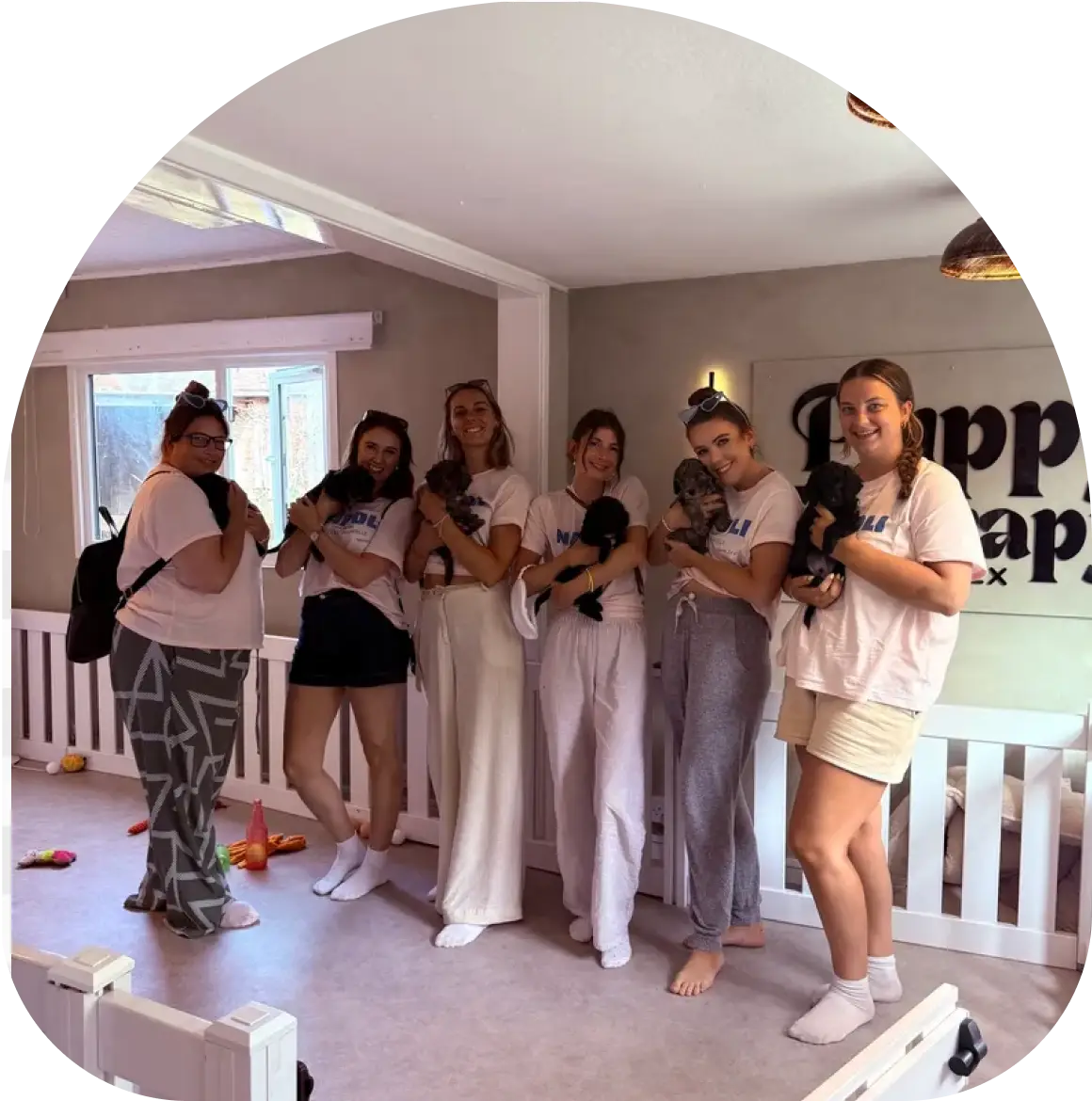 Friends posing with puppies