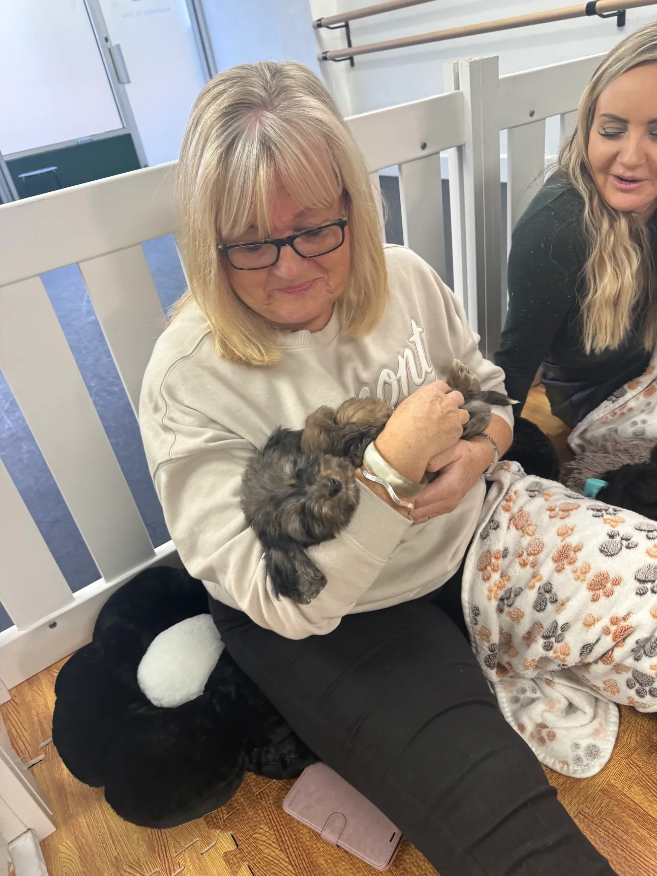 Woman cuddling a small dog