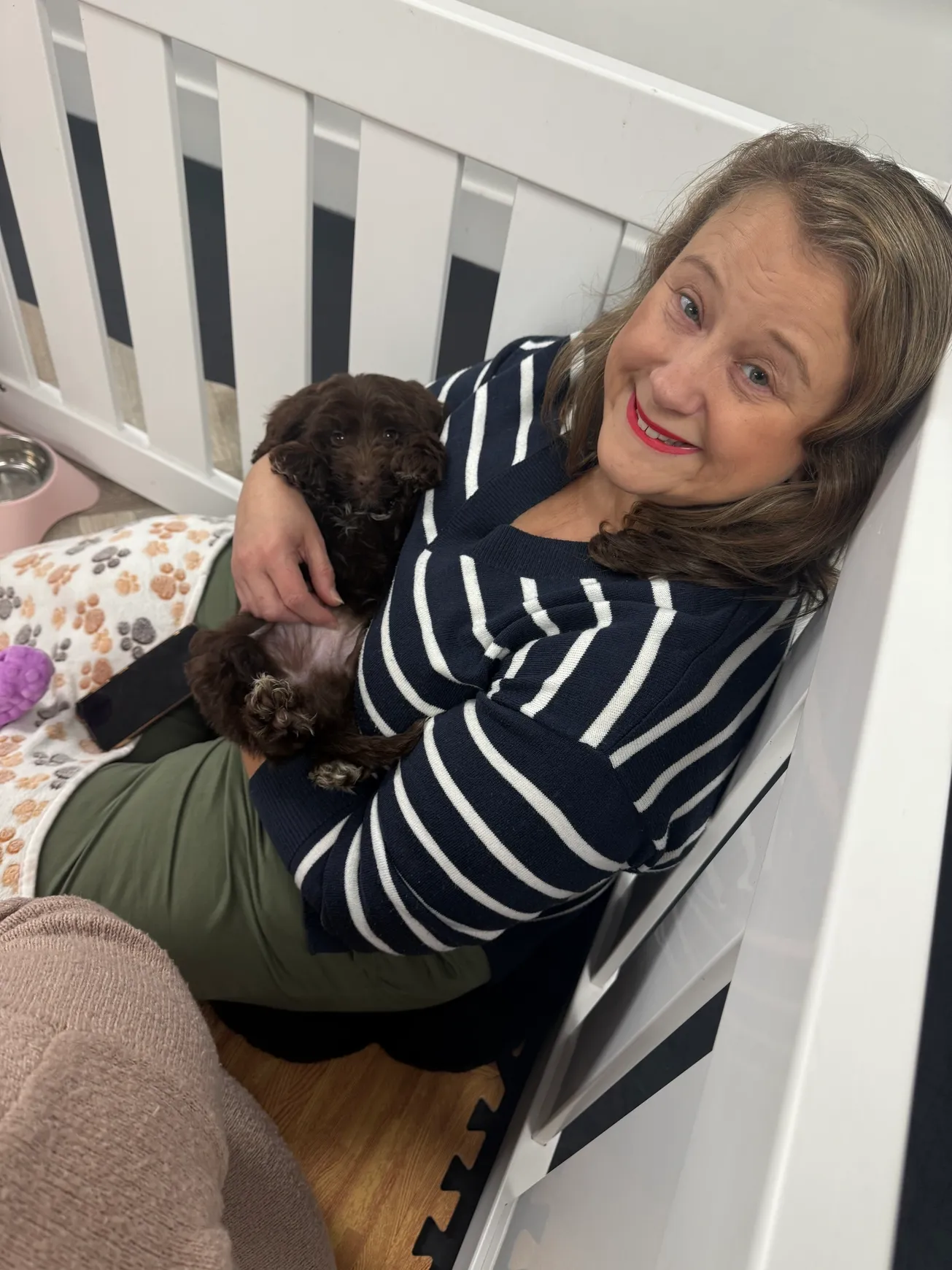 Smiling woman holding a small dog