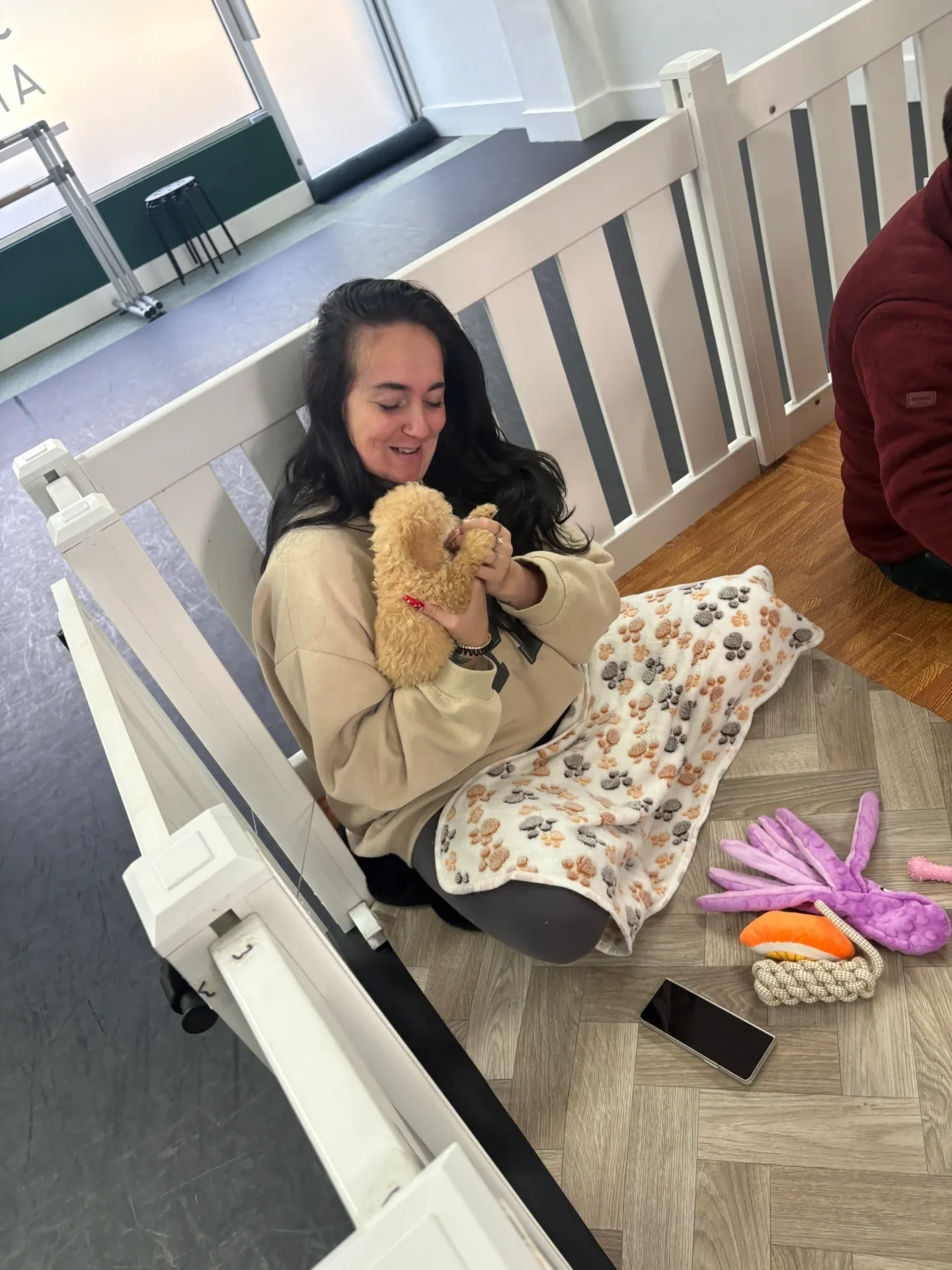 Woman sitting with a puppy indoors